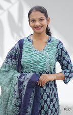 Woman wearing a blue and green patterned dress against a white background