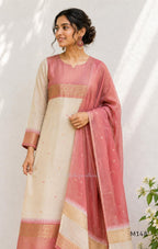 Rose pink and ivory tissue blend churidar set with woven gold borders, scattered motifs, straight bottom and matching dupatta.