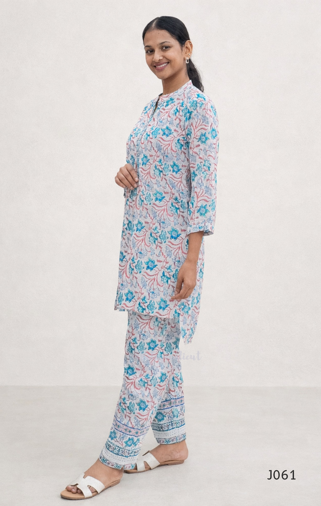 Woman wearing a floral pajama set on a white background