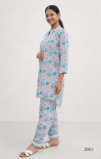 Woman wearing a floral pajama set on a white background