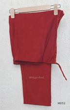 Red sleeveless top and pants set on a hanger against a white background