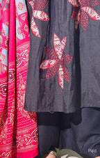 Close-up of fabric with red and white floral patterns on a dark background