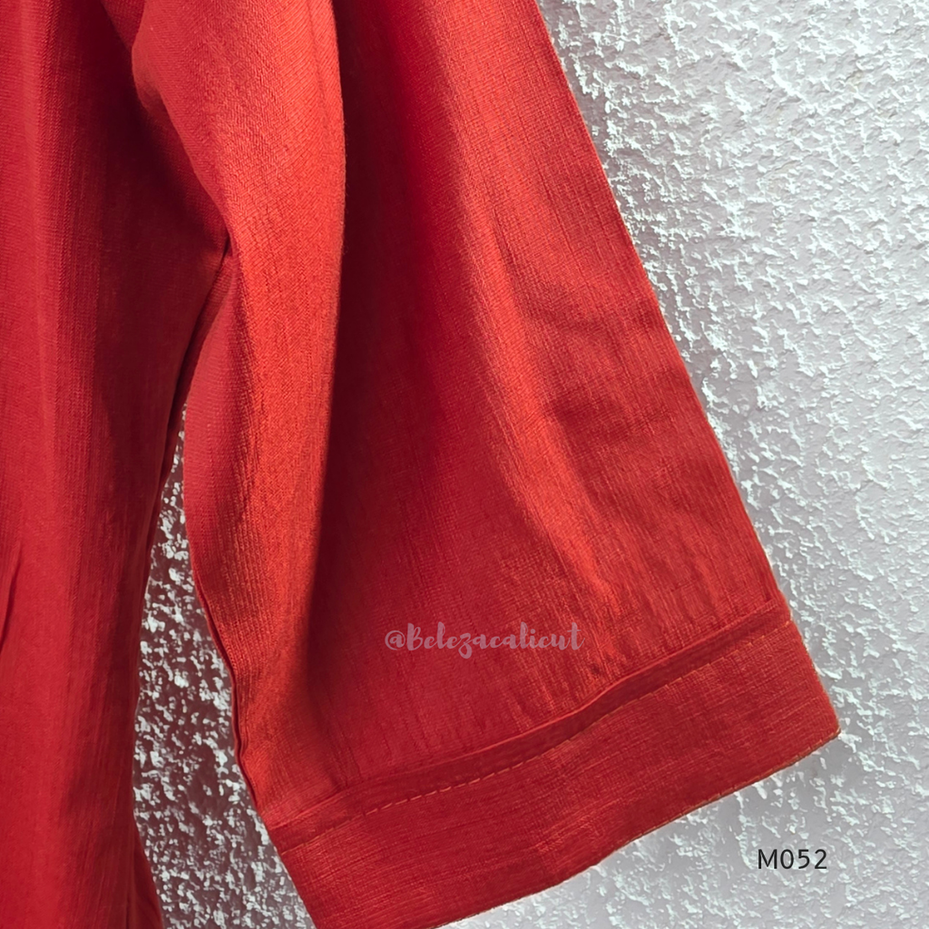 Close-up of a red fabric with a textured gray background