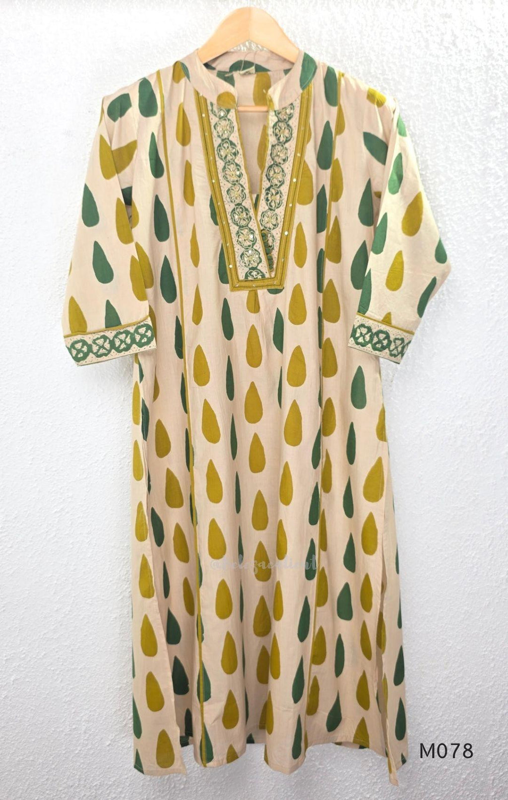 Beige cotton 3-piece churidar set with green and mustard drop motif, embroidered neckline, mustard bottom and printed dupatta.