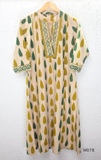Beige cotton 3-piece churidar set with green and mustard drop motif, embroidered neckline, mustard bottom and printed dupatta.