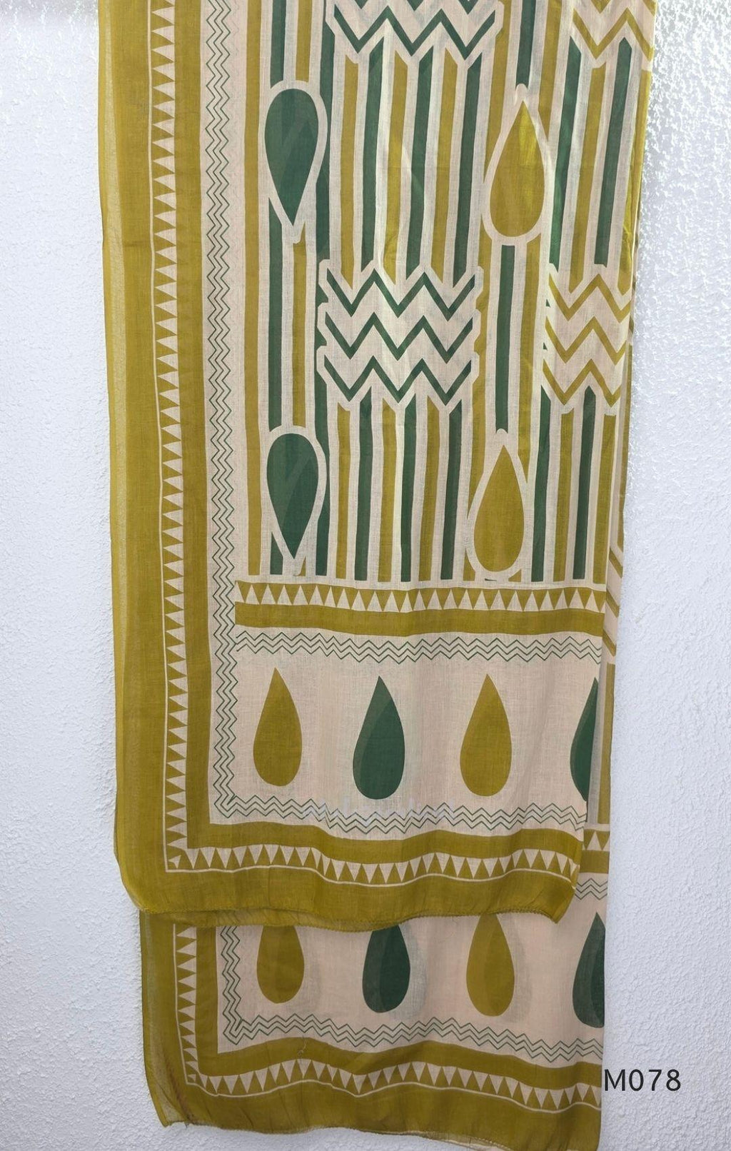 Beige cotton 3-piece churidar set with green and mustard drop motif, embroidered neckline, mustard bottom and printed dupatta.
