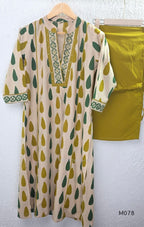 Beige cotton 3-piece churidar set with green and mustard drop motif, embroidered neckline, mustard bottom and printed dupatta.