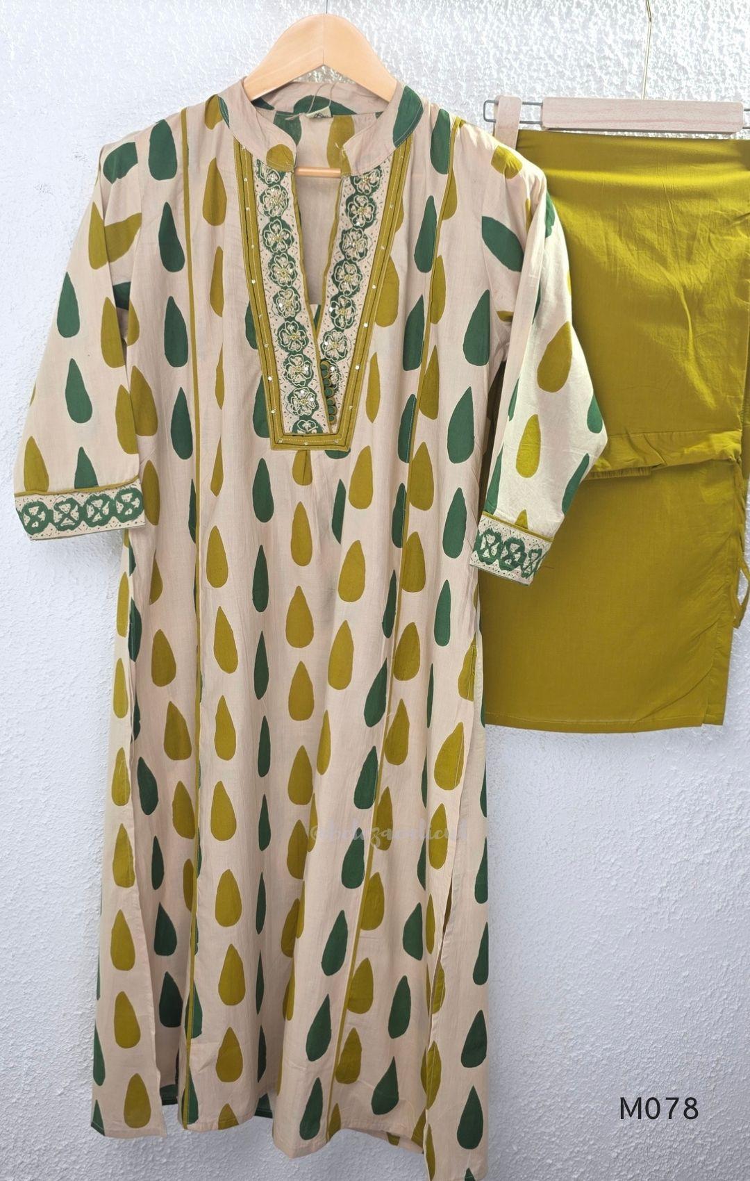 Beige cotton 3-piece churidar set with green and mustard drop motif, embroidered neckline, mustard bottom and printed dupatta.