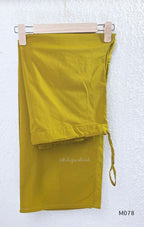 Beige cotton 3-piece churidar set with green and mustard drop motif, embroidered neckline, mustard bottom and printed dupatta.