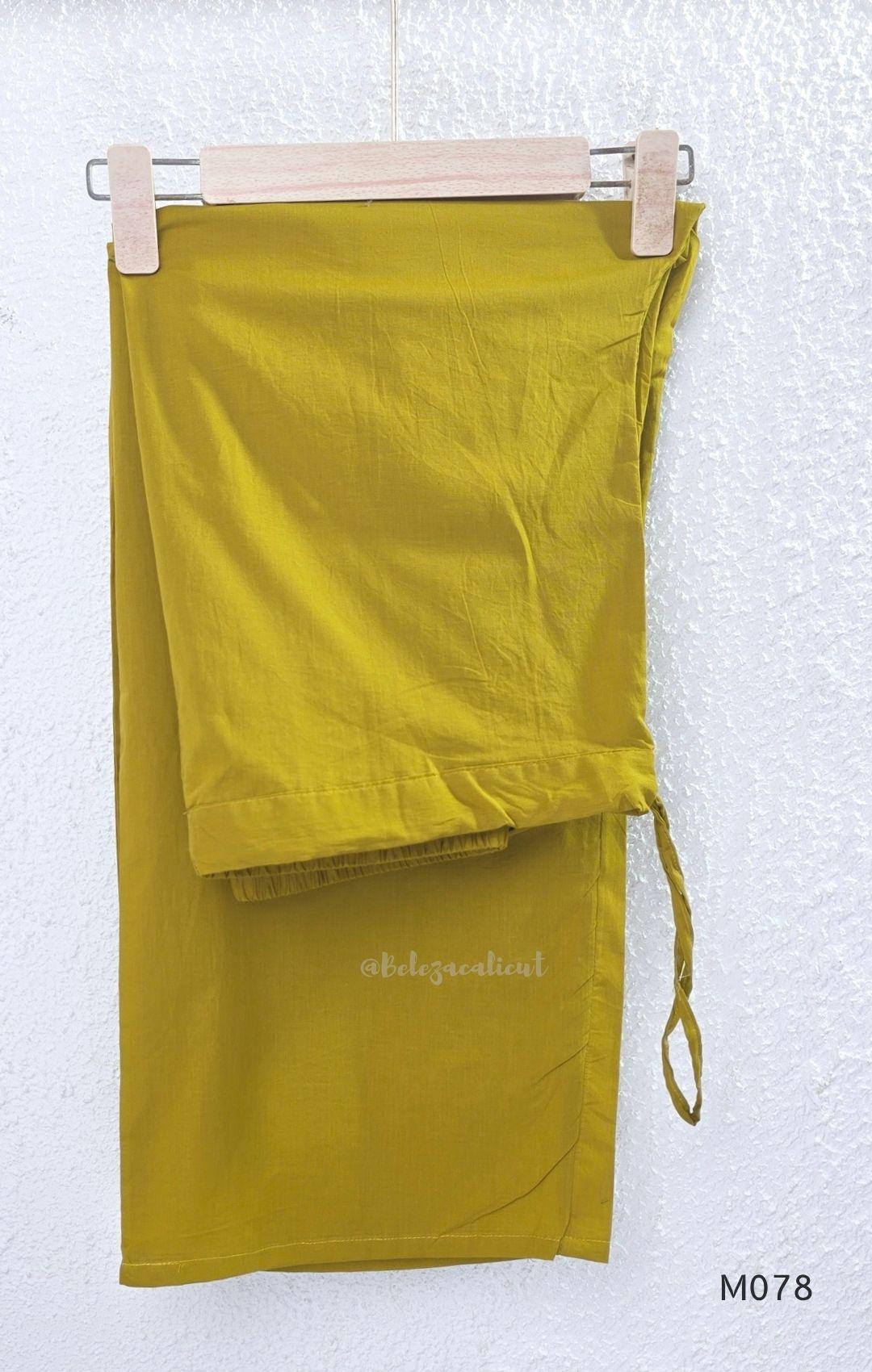 Beige cotton 3-piece churidar set with green and mustard drop motif, embroidered neckline, mustard bottom and printed dupatta.