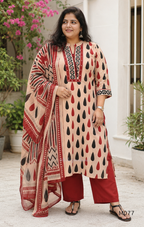 Beige cotton churidar set with red and black teardrop print, embroidered neckline, contrast red bottom and printed dupatta.