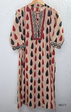 Beige cotton churidar set with red and black teardrop print, embroidered neckline, contrast red bottom and printed dupatta.