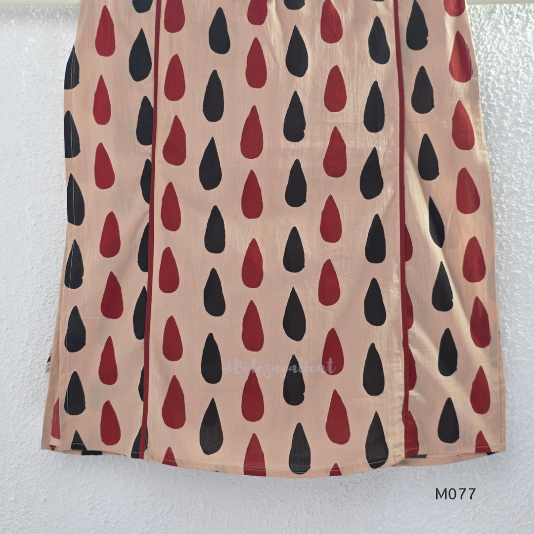 Beige cotton churidar set with red and black teardrop print, embroidered neckline, contrast red bottom and printed dupatta.