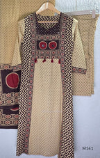 Beige cotton churidar set with dark brown geometric print, red accents, mirror-work yoke, tassels and coordinated dupatta.