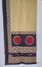 Beige cotton churidar set with dark brown geometric print, red accents, mirror-work yoke, tassels and coordinated dupatta.