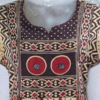 Beige cotton churidar set with dark brown geometric print, red accents, mirror-work yoke, tassels and coordinated dupatta.