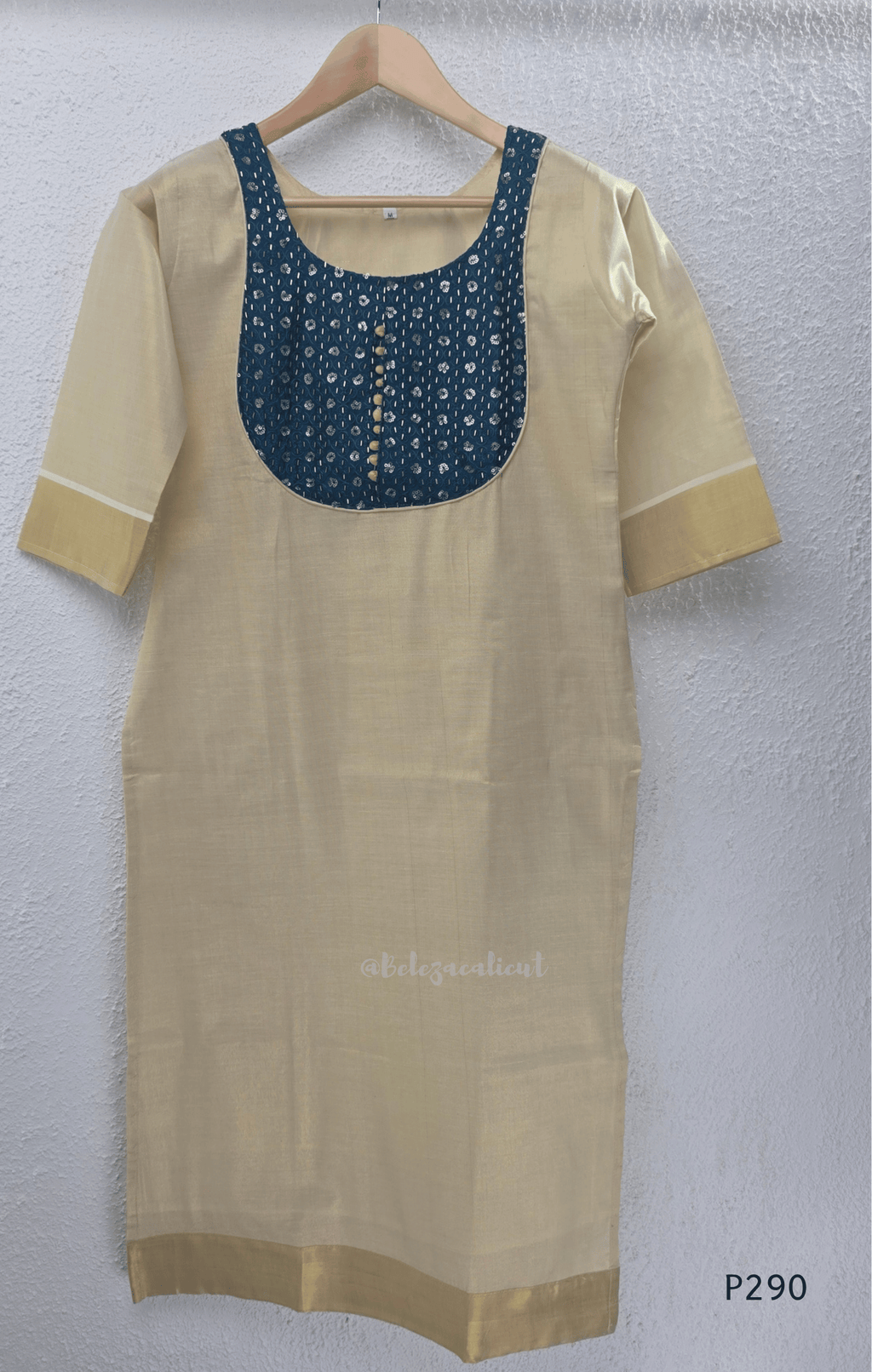 Beige cotton women’s ethnic top with teal embroidered yoke, short sleeves, and simple straight fit.