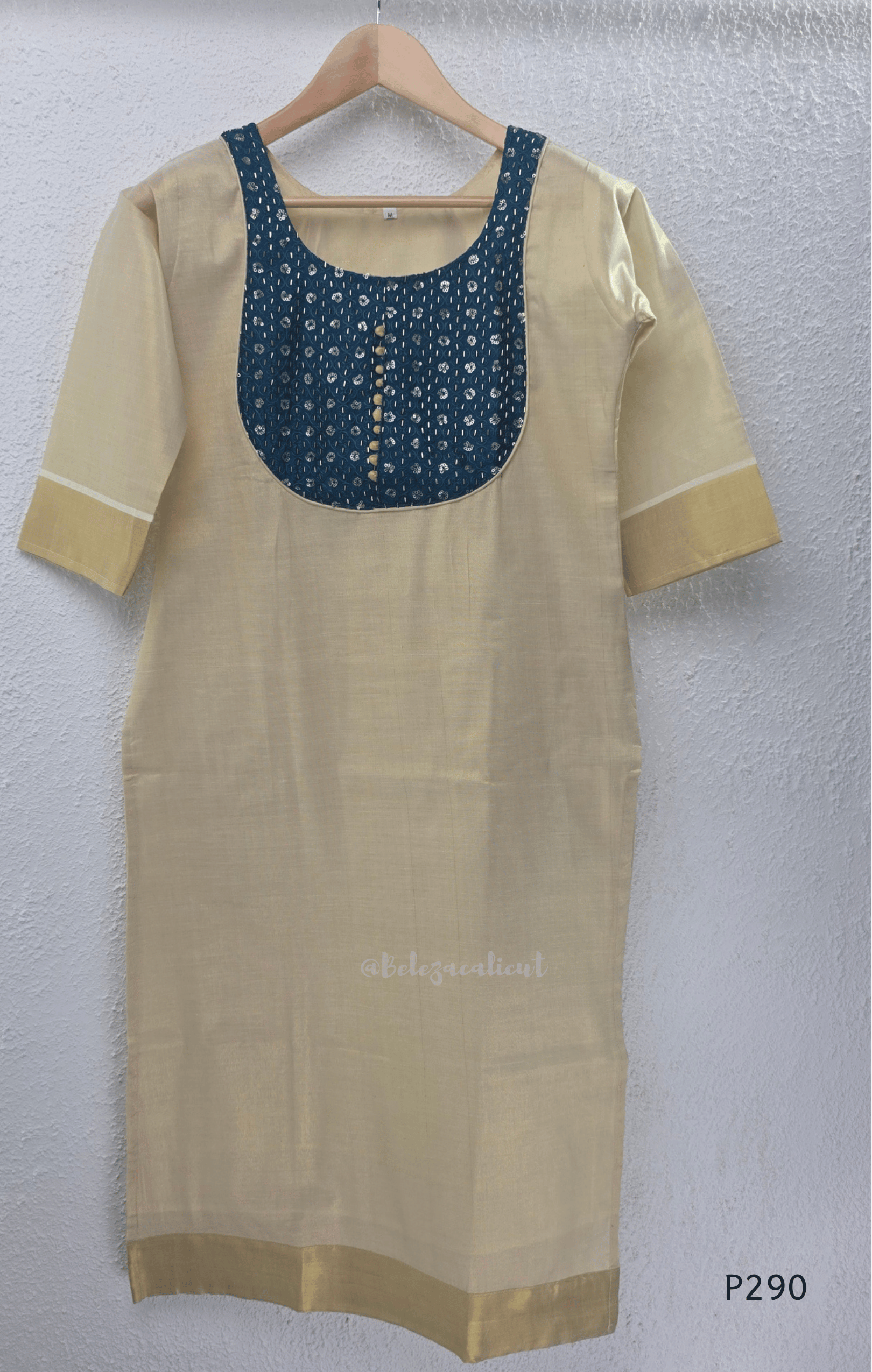 Beige cotton women’s ethnic top with teal embroidered yoke, short sleeves, and simple straight fit.