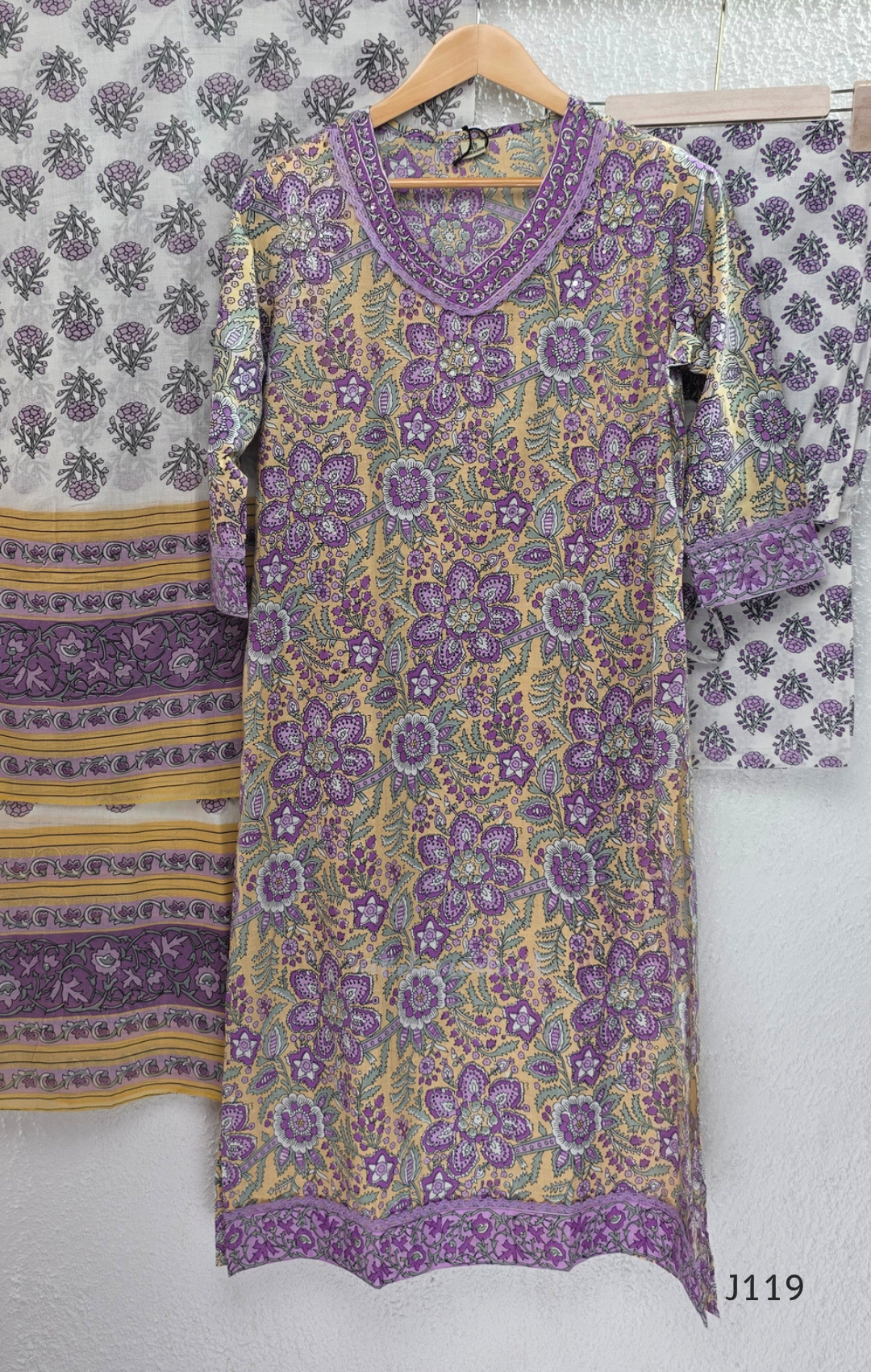 Beige mustard cotton 3-piece churidar set with lavender floral block print, gold V-neckline detail, ivory dupatta and matching printed bottom.