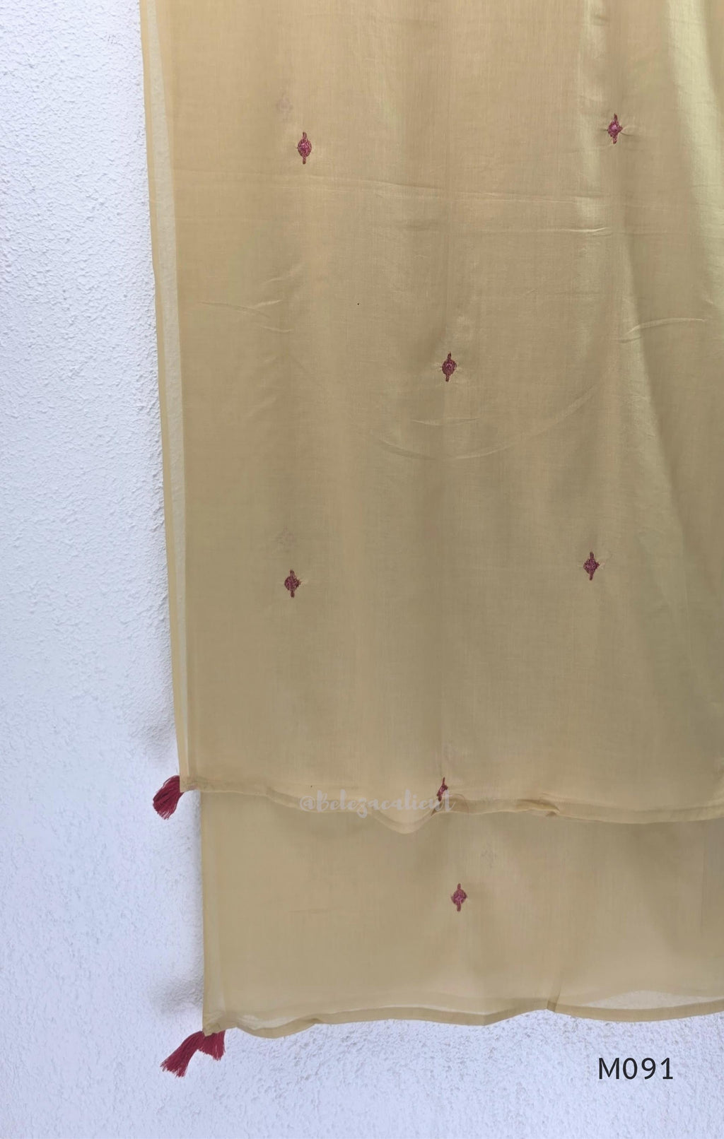 Warm beige cotton 3-piece churidar set with pink and mustard ikat-style print, mirror-trimmed V-neck, plain beige bottom and matching dupatta.