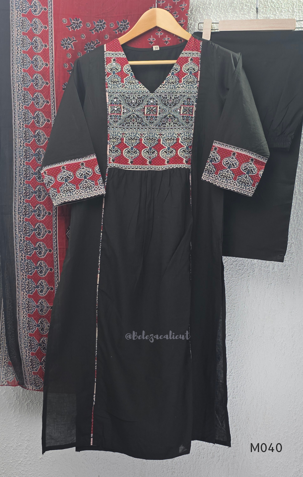 Black cotton 3-piece churidar set with red Ajrakh-style printed yoke, matching printed dupatta, and plain black pant.