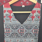 Black cotton 3-piece churidar set with red Ajrakh-style printed yoke, matching printed dupatta, and plain black pant.