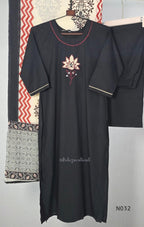 Black cotton three-piece churidar set with a cream floral appliqué, red embroidery, mirror details, black palazzo pants and a cream printed dupatta.