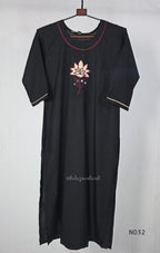 Black cotton three-piece churidar set with a cream floral appliqué, red embroidery, mirror details, black palazzo pants and a cream printed dupatta.
