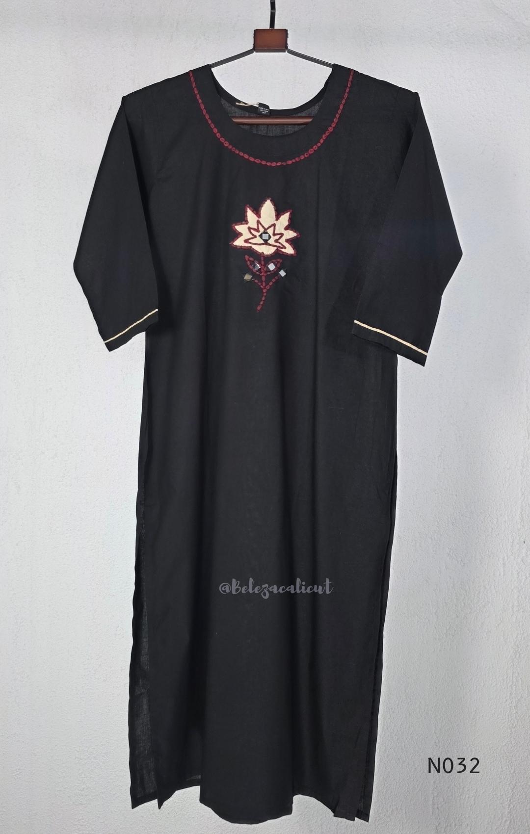 Black cotton three-piece churidar set with a cream floral appliqué, red embroidery, mirror details, black palazzo pants and a cream printed dupatta.