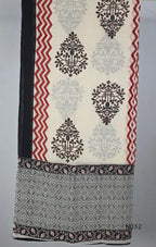 Black cotton three-piece churidar set with a cream floral appliqué, red embroidery, mirror details, black palazzo pants and a cream printed dupatta.