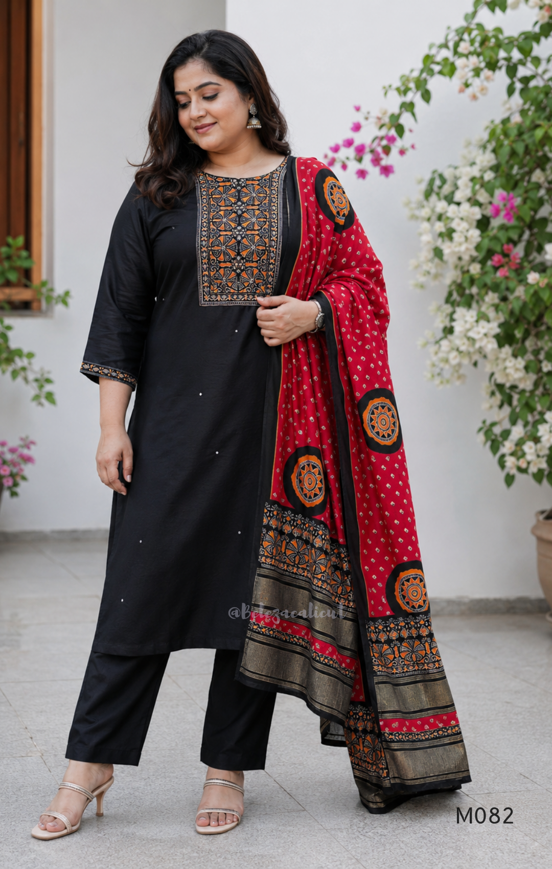 Black Gajji silk plus size churidar set with embroidered yoke, sleeve border, matching black bottom and contrast red printed dupatta.