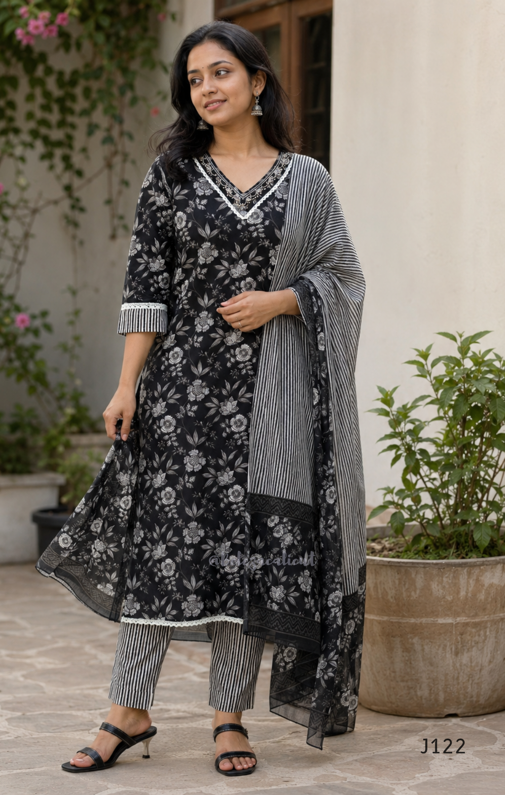 Black Jaipur cotton 3-piece churidar set with grey-white floral print, V-neck detail, printed dupatta and striped matching bottom.