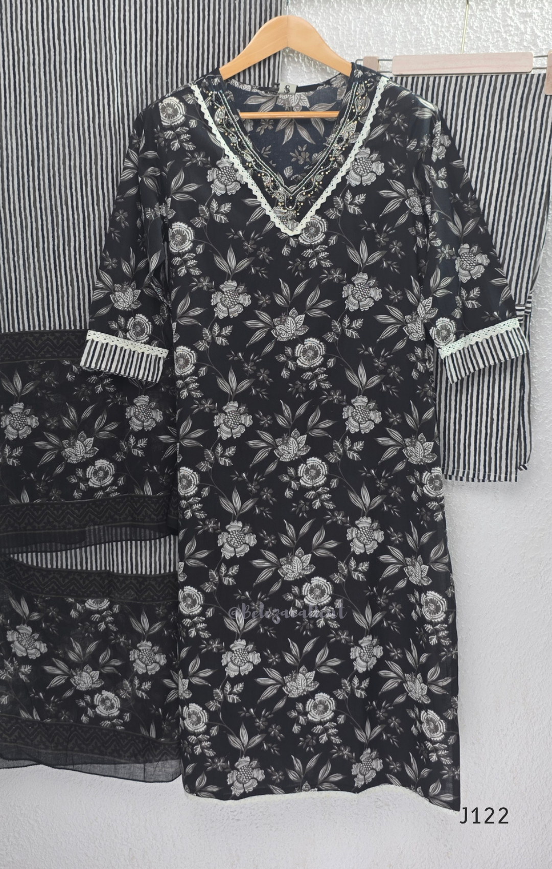 Black Jaipur cotton 3-piece churidar set with grey-white floral print, V-neck detail, printed dupatta and striped matching bottom.