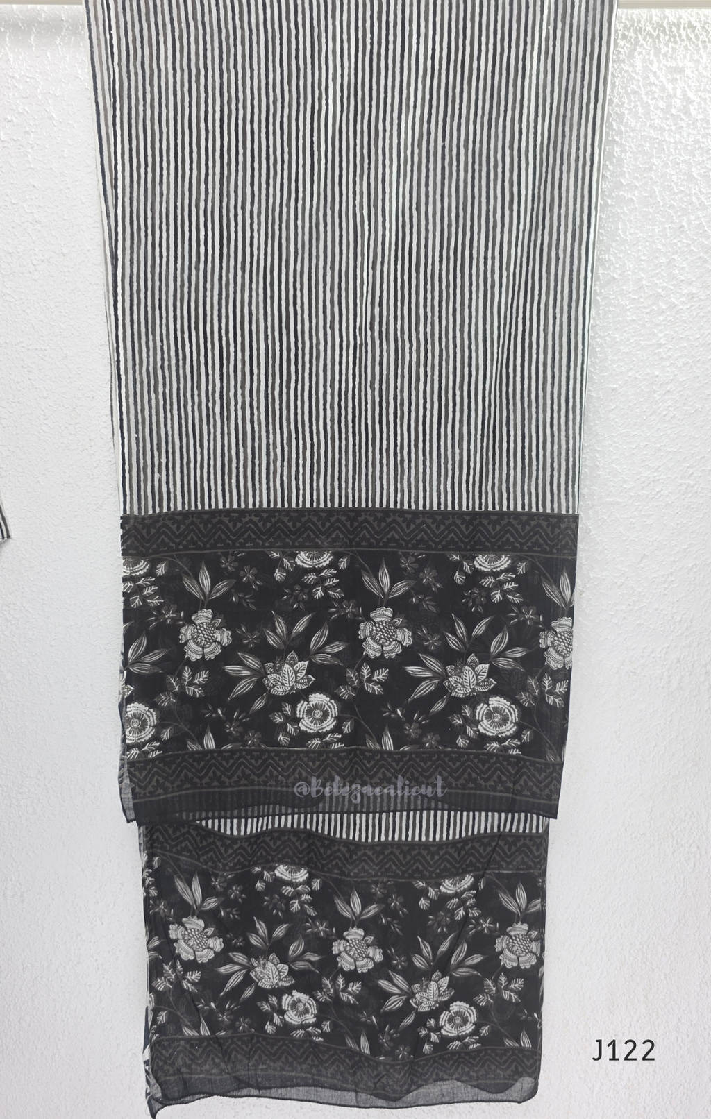 Black Jaipur cotton 3-piece churidar set with grey-white floral print, V-neck detail, printed dupatta and striped matching bottom.