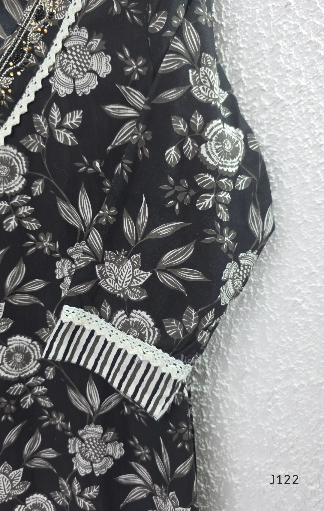 Black Jaipur cotton 3-piece churidar set with grey-white floral print, V-neck detail, printed dupatta and striped matching bottom.