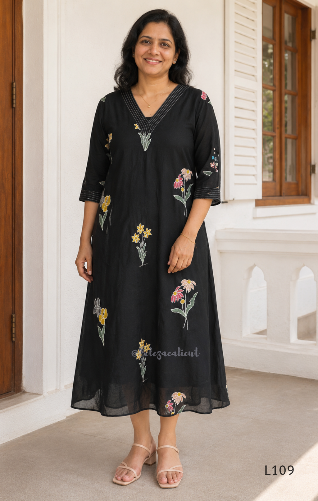Black mul chanderi A-line kurti with colourful floral embroidery, V-neck stitch detail and 3/4 sleeves