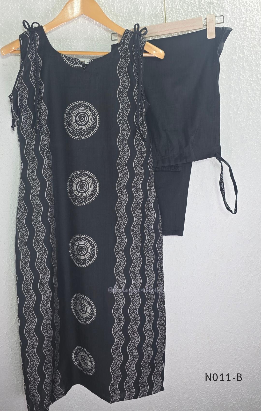 Black Vertigan silk printed co-ord set with straight mid-calf top and matching straight pants.