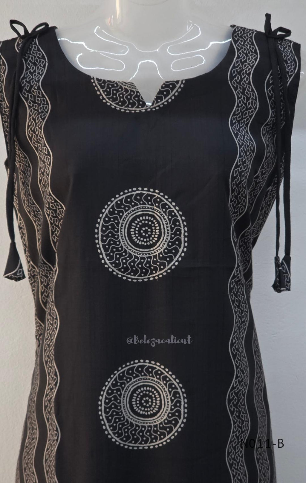 Black Vertigan silk printed co-ord set with straight mid-calf top and matching straight pants.