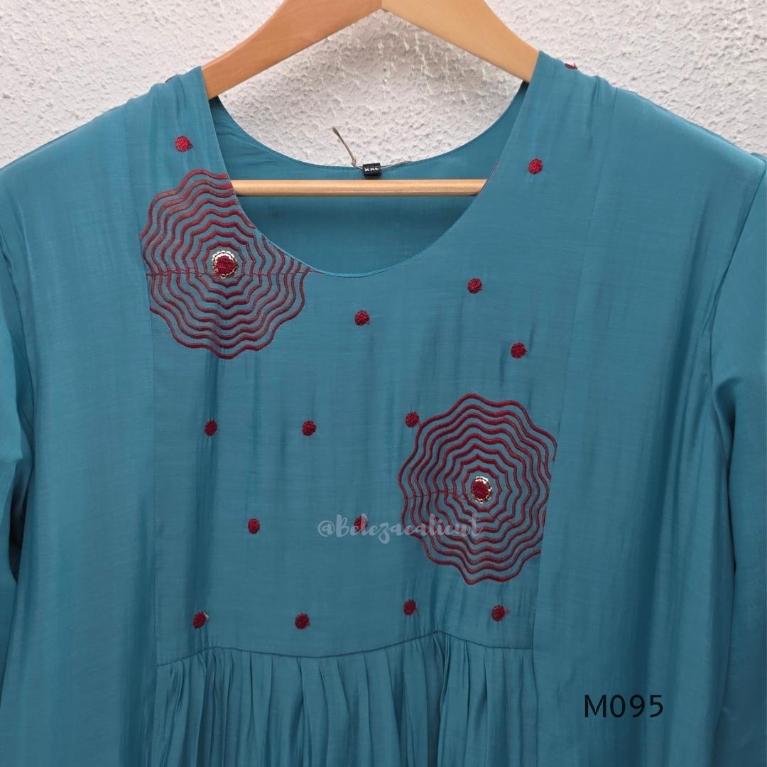 Black and teal blue Mul Chanderi 3-piece churidar sets with red circular embroidery and coordinated dupattas.