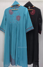 Black and teal blue Mul Chanderi 3-piece churidar sets with red circular embroidery and coordinated dupattas.