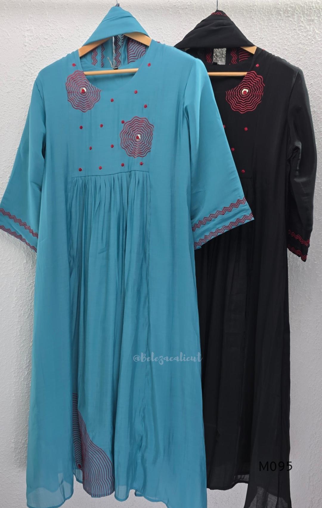 Black and teal blue Mul Chanderi 3-piece churidar sets with red circular embroidery and coordinated dupattas.