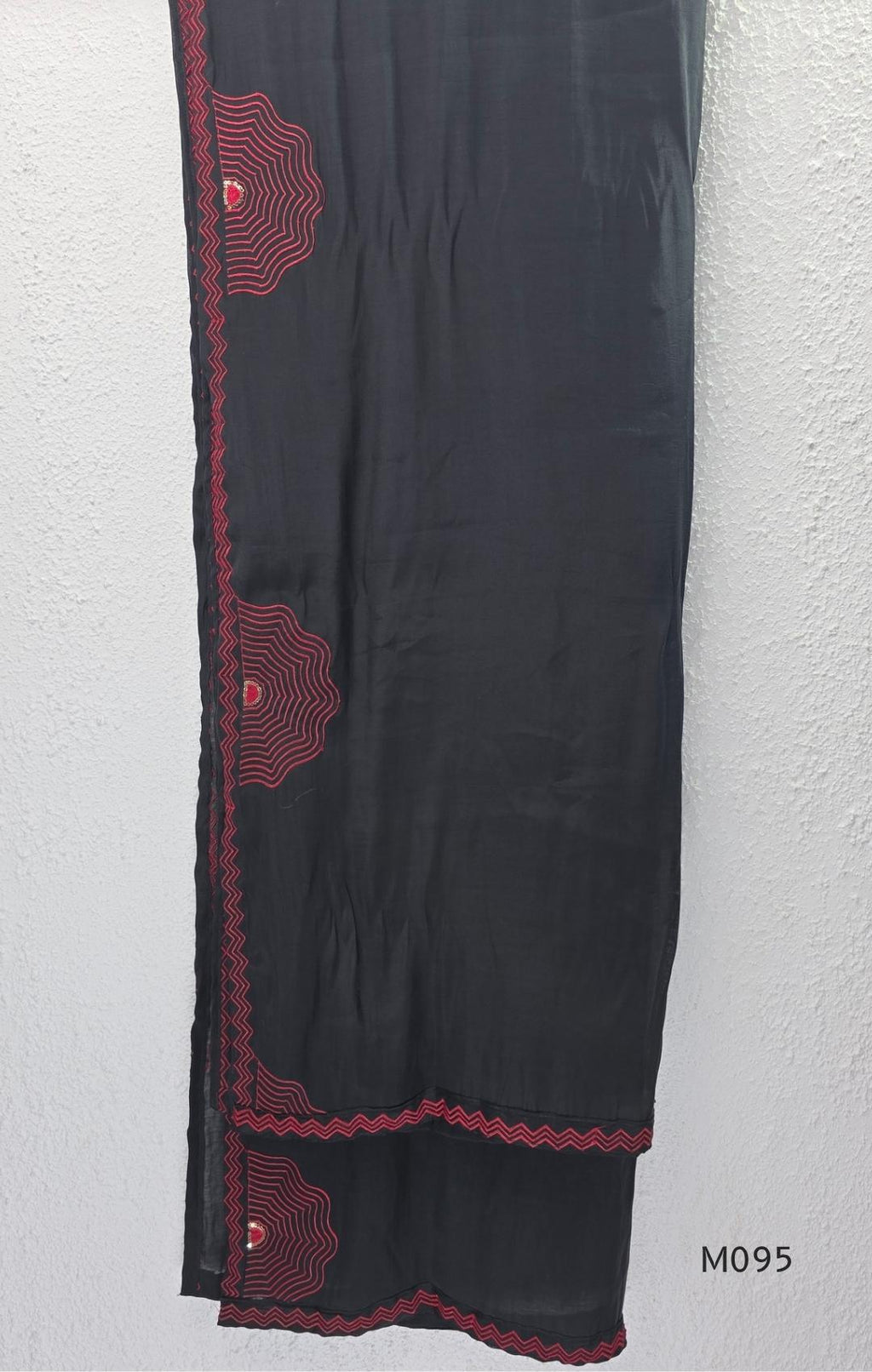 Black and teal blue Mul Chanderi 3-piece churidar sets with red circular embroidery and coordinated dupattas.