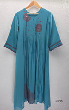Black and teal blue Mul Chanderi 3-piece churidar sets with red circular embroidery and coordinated dupattas.
