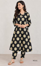 Black cotton co-ord set with muted beige dotted-circle print, A-line mid-calf top and matching tapered pants.
