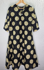 Black cotton co-ord set with muted beige dotted-circle print, A-line mid-calf top and matching tapered pants.