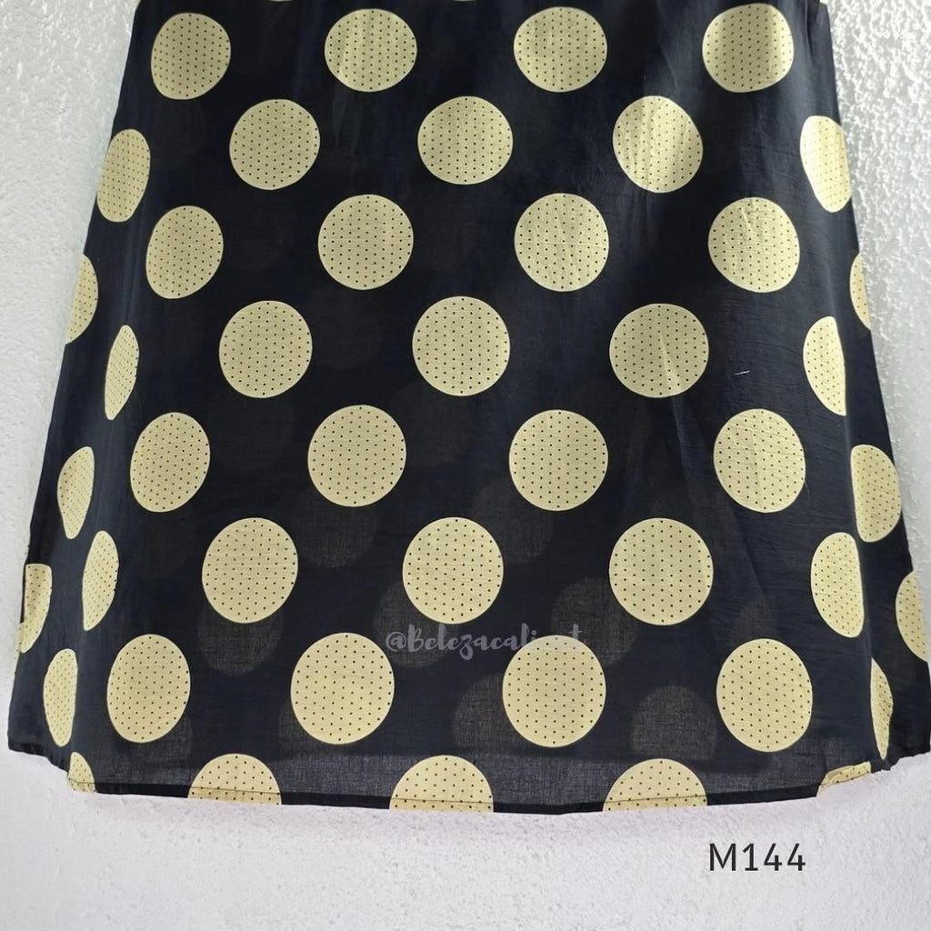 Black cotton co-ord set with muted beige dotted-circle print, A-line mid-calf top and matching tapered pants.
