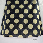 Black cotton co-ord set with muted beige dotted-circle print, A-line mid-calf top and matching tapered pants.