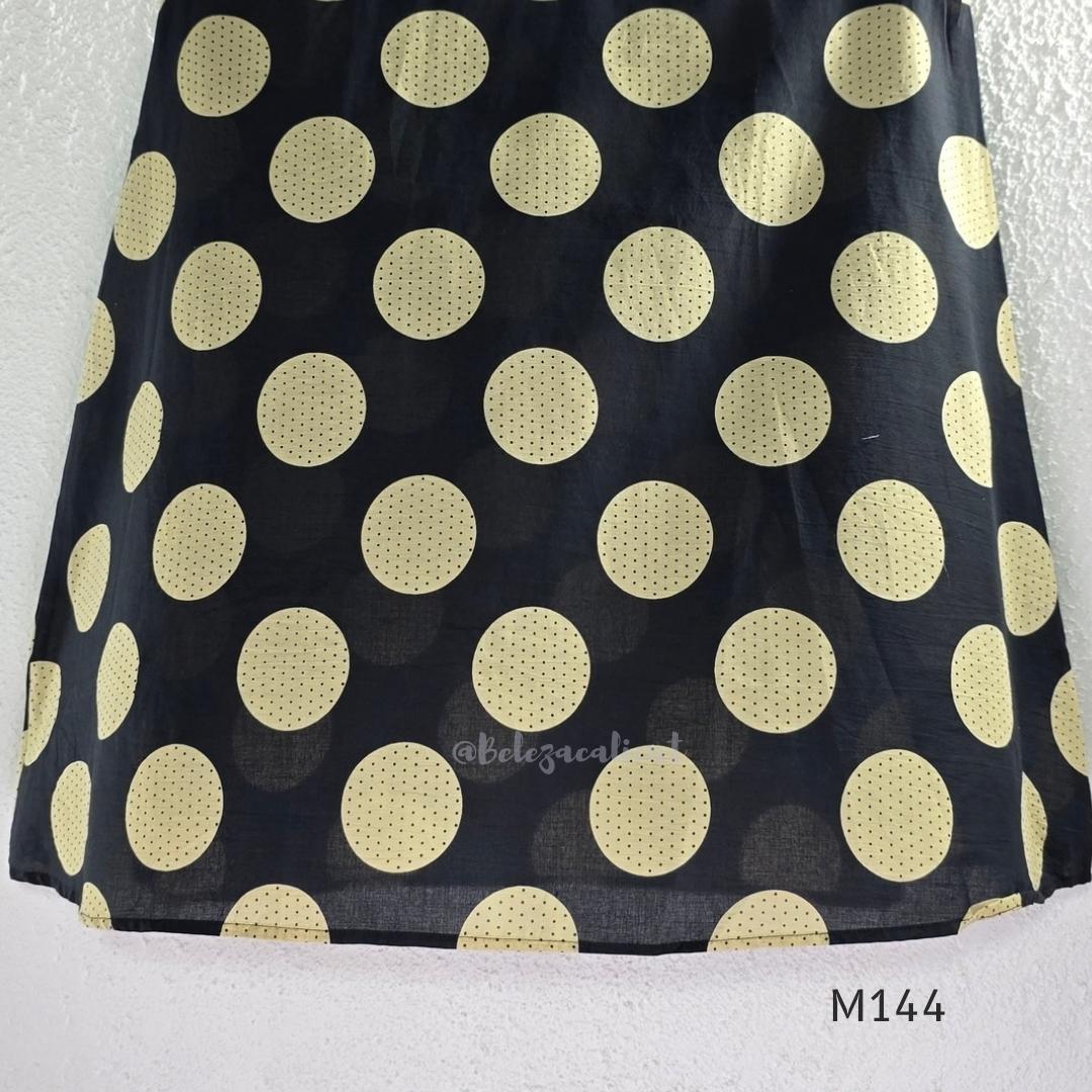 Black cotton co-ord set with muted beige dotted-circle print, A-line mid-calf top and matching tapered pants.
