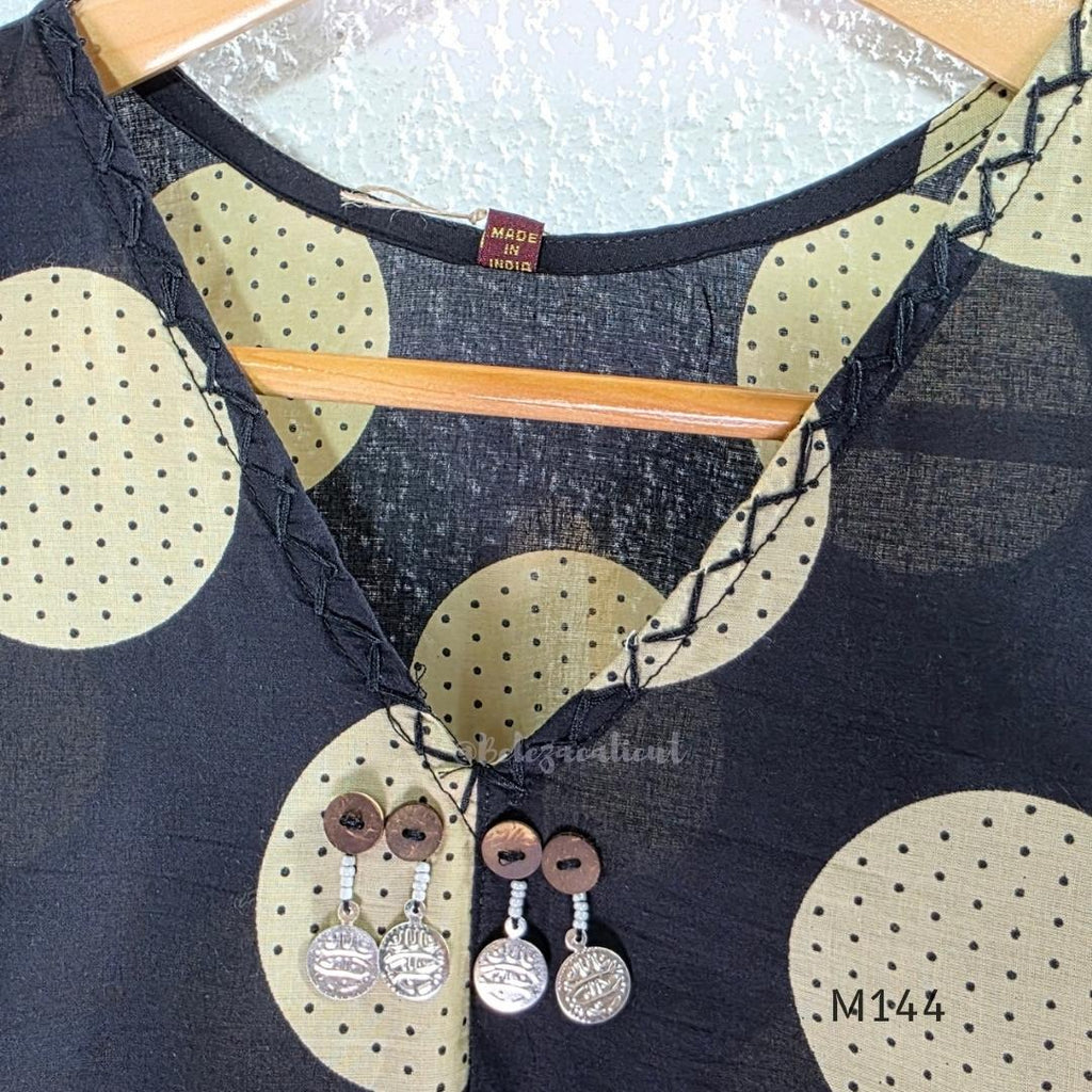 Black cotton co-ord set with muted beige dotted-circle print, A-line mid-calf top and matching tapered pants.