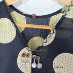 Black cotton co-ord set with muted beige dotted-circle print, A-line mid-calf top and matching tapered pants.
